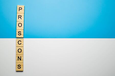 "Pros and Cons" word in the wooden block on duo color backgroundの写真素材