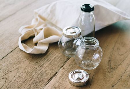 Cloth bag and glass jars on wooden table, no plastic packages, zero waste conceptの写真素材