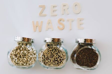 "zero waste" word on the white background with grain glass jarsの写真素材