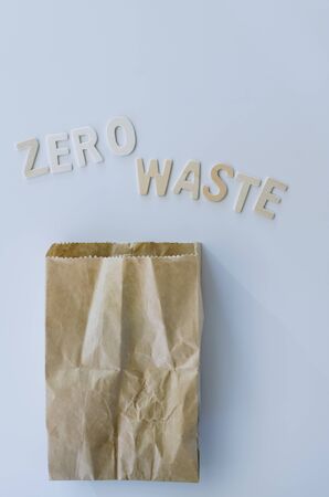 "zero waste" word on the white background with used paper bagの写真素材