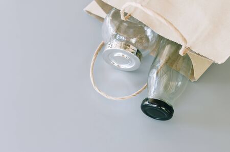 paper bag and glass wares on grey background, no plastic packages, zero waste conceptの写真素材