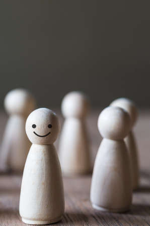 Close up standing wooden dolls, row of human represent figure on the table, blurred and select focusの写真素材