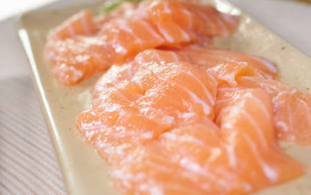 Salmon sashimi on a rectangular plateの写真素材