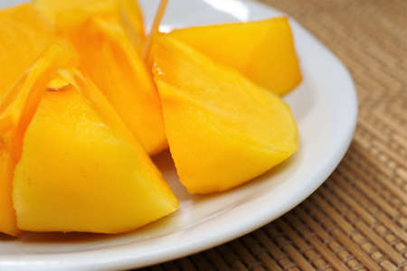 Cut persimmon fruitの写真素材