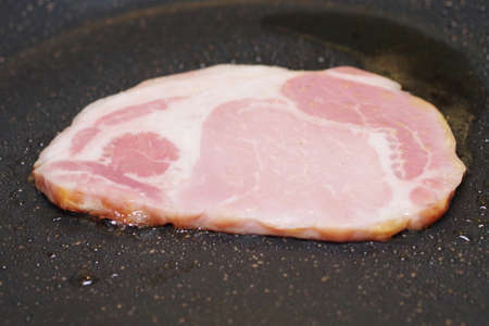 Cooking ham in a frying panの写真素材
