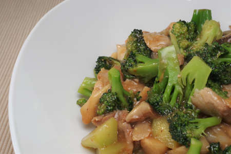 Stir-fried broccoli, shiitake mushrooms and porkの写真素材