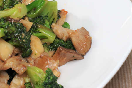 Stir-fried broccoli, shiitake mushrooms and porkの写真素材