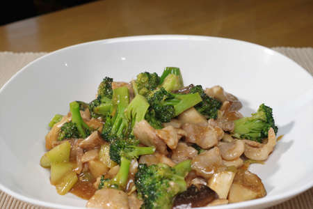 Stir-fried broccoli, shiitake mushrooms and porkの写真素材