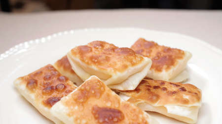 Baked dumpling skins wrapped in cheese for a snackの写真素材