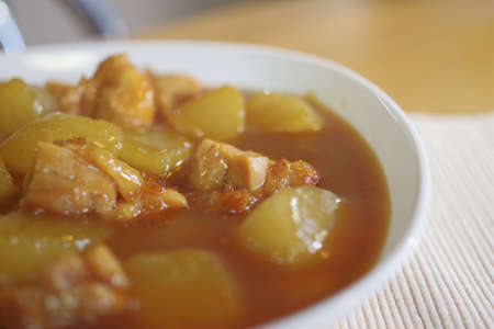 Curry-flavored simmered radish and chickenの写真素材