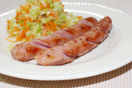 Cooked sausage and garnished vegetablesの写真素材