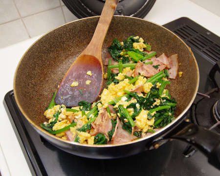 Stir-fried egg, spinach and baconの写真素材