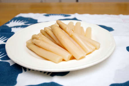Pour canned white asparagus on a plateの写真素材