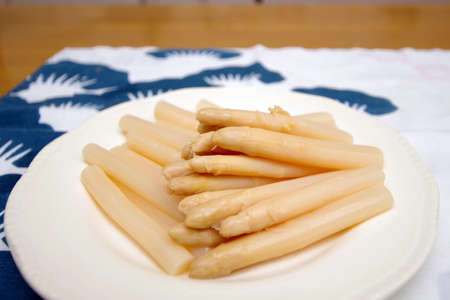 Pour canned white asparagus on a plateの写真素材