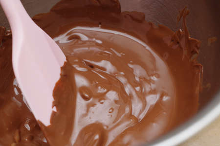 Mixing melted chocolate in a bowl.