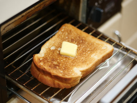 Toast with butter in a toaster, close-up.