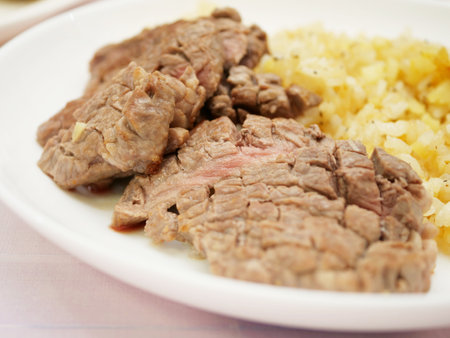 Beef steak with rice on a plate. Close-up.の写真素材