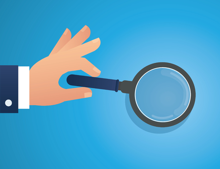 Hand holding the magnifying glass.のイラスト素材