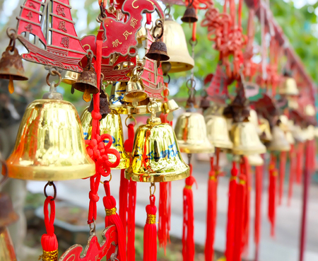 rows of red wind bells golden buddhist prosperity bell at chinese temple people wish and hang themの写真素材
