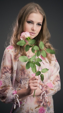 Portrait of young girl that holds delicate roseの写真素材