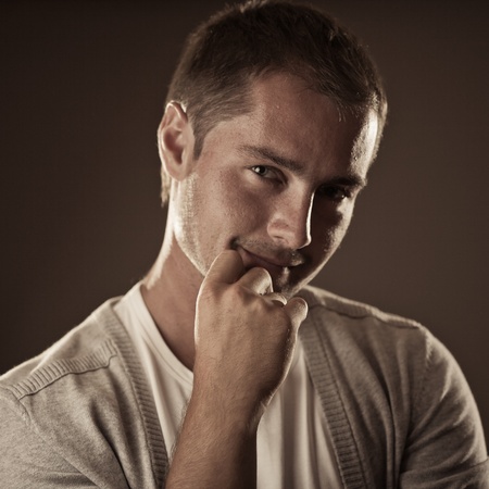 Attractive young man over black backgroundの写真素材