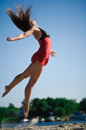 Young girl jumping and dancingの写真素材