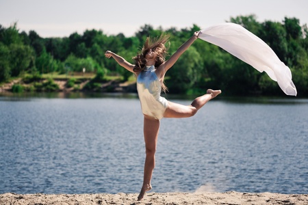 Young pretty girl dancing outdoorsの写真素材