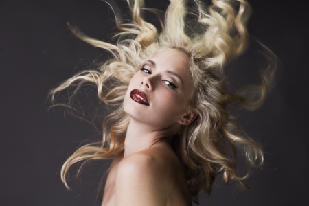 Fashion portrait of gorgeous blond on dark backgroundの写真素材
