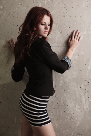 Fashion sensual portrait of young sexy redhead girl over grunge wallの写真素材