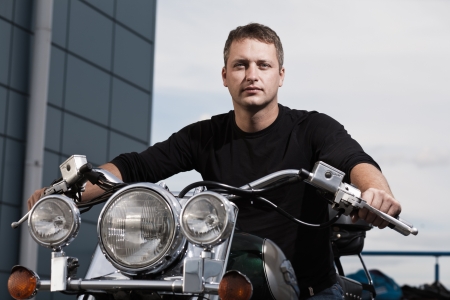 Portrait of mid aged man with motorcycleの写真素材