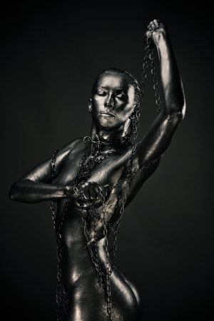 Nude woman like statue in liquid metal posingの写真素材