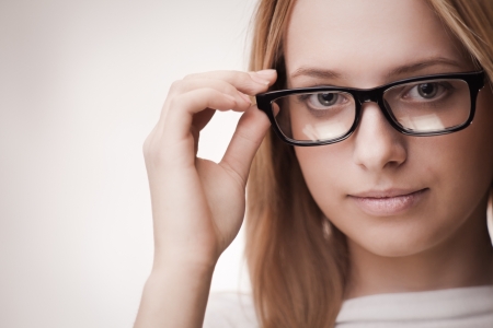 Portrait of young attractive girl with long hair in glassesの写真素材