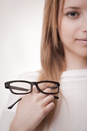 Girl holding glasses, selective focus on glasses  Concept  poor eyesightの写真素材