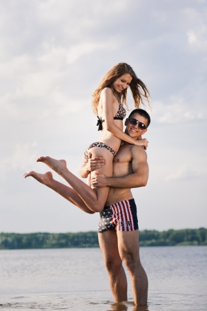 Attractive young heterosexual couple on beachの写真素材