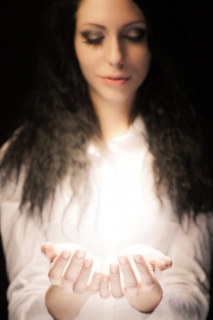 Young girl with something magic in her handsの写真素材