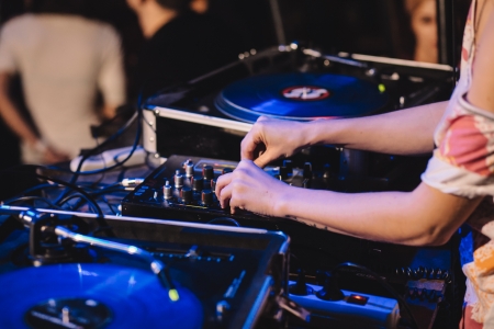 Young Dj Girl working in the nightclub. Shallow depth of fieldの写真素材