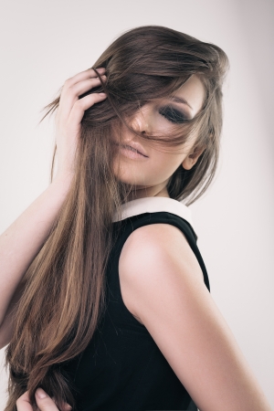 Sensual fashion portrait of young brunette girl with long hairの写真素材