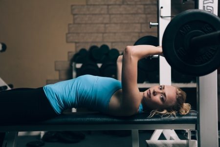 Young blond woman doing practice in gymの写真素材