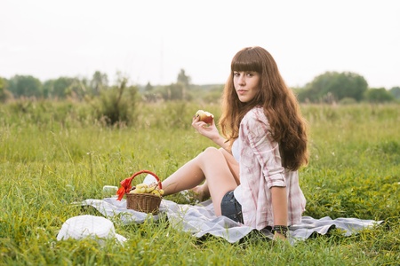 Young brunette woman enjoying picnicの写真素材