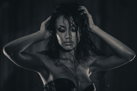 Fashion portrait of gorgeous brunette with wet hair on wooden background. Black and whiteの写真素材