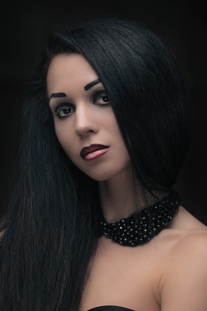 Fashion portrait of gorgeous brunette on blackの写真素材
