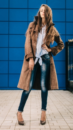 Fashion portrait of young brunette in full length on streetの写真素材