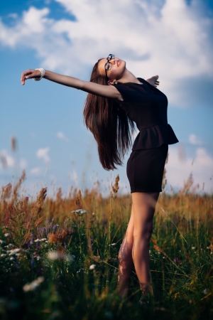 Gorgeous brunette in glasses outdoors in business suitの写真素材