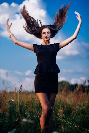 Gorgeous brunette in glasses outdoors in business suitの写真素材