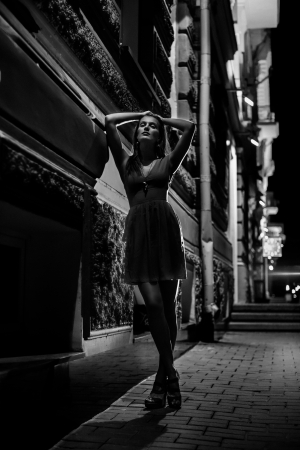 Art fashion portrait of young woman in night street. Shallow depth of fieldの写真素材