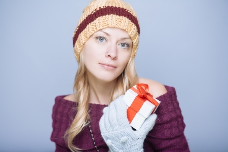 Young blond woman with little gift boxの写真素材