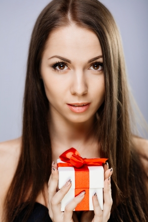 Portrait of gorgeous brunette with gift boxの写真素材
