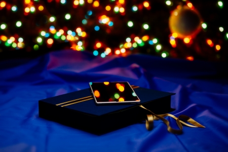 Gift box with cell phone and colorful lights on backgroundの写真素材