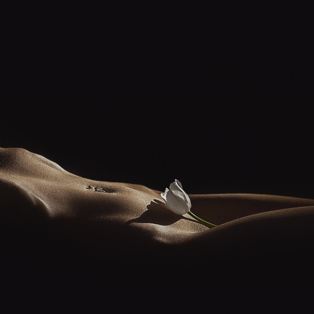 Beautiful body of young woman, isolated on black.の写真素材