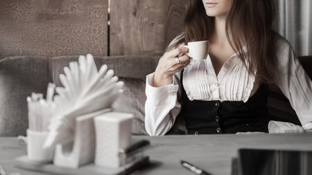 Fashion art portrait of young pretty business woman in restaurantの写真素材